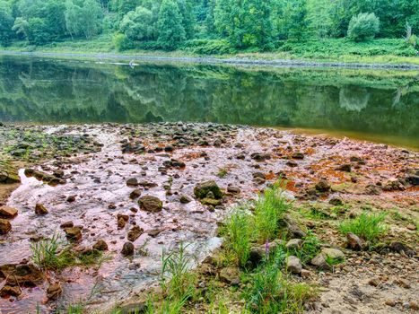 Low water level, empty river inflow. Muddy horrible smell water poisoning the rest of life. Ecology disaster.