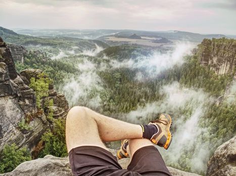 Reached summit of mountain peak. Climbing and hiking sport concept. Tourist take a rest