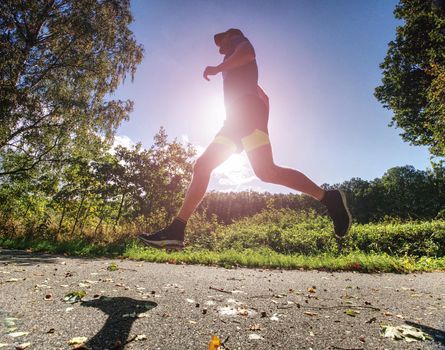 Man jogger run in park sunny day nature background. Man training, prepare his body for marathon