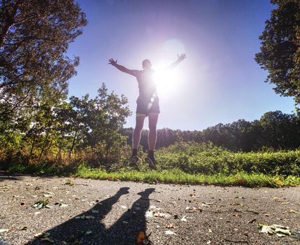 Action man, full of strength sportsman wearing shorts and sneakers, he is running a marathon, 