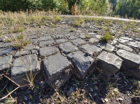 Ruined old cobble stone way. Paving Stones Road. Crawl destroyed urban sidewalk construction stones 