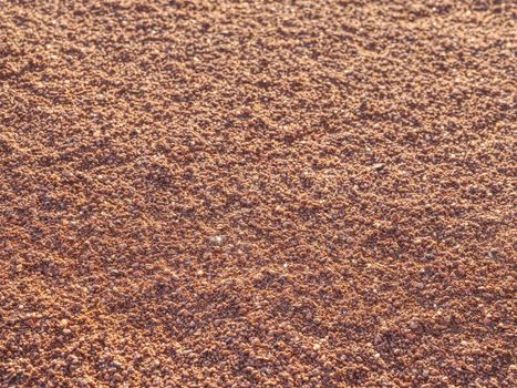 Red clay court trampled pattern by tennis player and serviceman footprints.  Marks on a outside tennis court in details