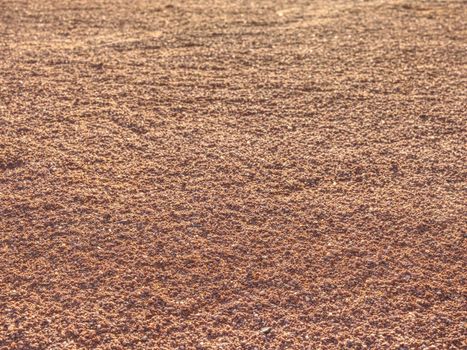 Red clay court trampled pattern by tennis player and serviceman footprints.  Marks on a outside tennis court in details