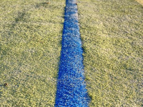 Border line in handball playing field.  The outdoor handball playground plastic light green surface on ground.