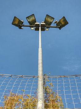 Spotlight tower with blue sky. The stadium light tower  with evening  blue sky