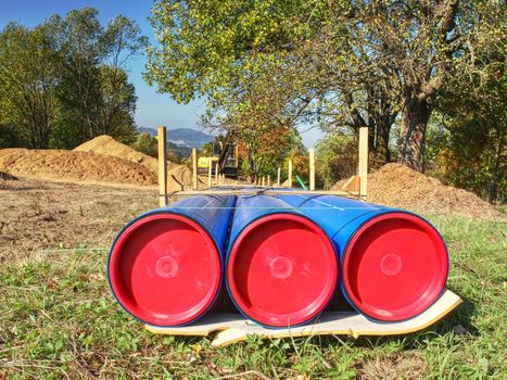 New water pipe at trench, spare part. Service company prepare replacement of old corroded steel water pipelines by new HDPE tubes.