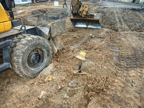 Potable water pipes rebuilding. Old excavator performs excavation work on the construction site of old town potable water system