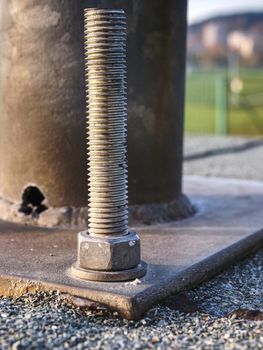 Detail of bolts. Steel plate based on anchor bolts on the concrete pillar.