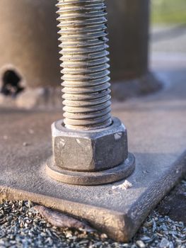 Detail of bolts. Steel plate based on anchor bolts on the concrete pillar.