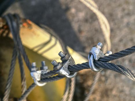 Shackles attached to wire cables and safety net.  Stainless steel screw bolt and wires for maintaining tightened safety net