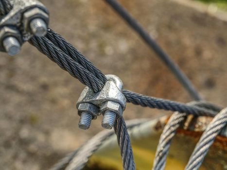 Shackles attached to wire cables and safety net.  Stainless steel screw bolt and wires for maintaining tightened safety net