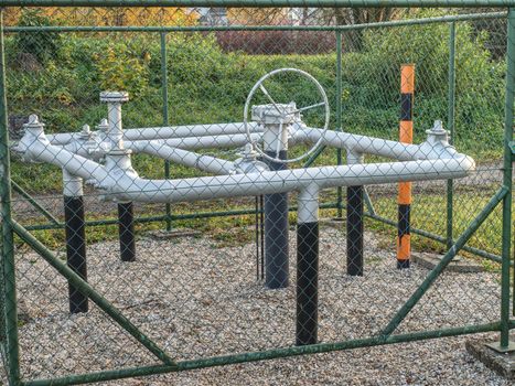 Control valve and latch of underground gas pipeline protected with a fence.