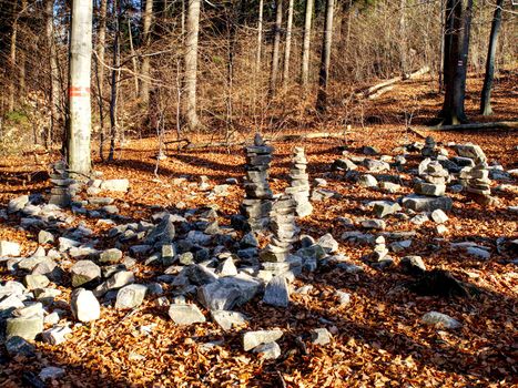 Area in the forest covered with many mysterious piles of stones in autumn.