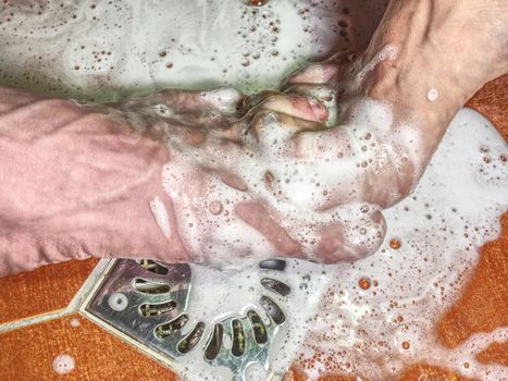 Adult pair of lovers stay together and splashes the water of the shower.