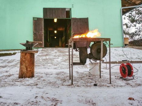 Blacksmith hot coals in a clay oven. Smith heating iron metal sword manufacturing marching forge