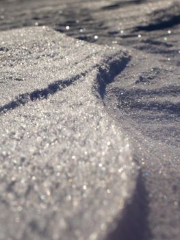 Snow ground with shadows and reflections. REal snow on a glass detail of snow in the winter cold and ice