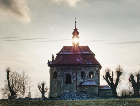 Old catholic chapel with renewal roof on the hill at Sunset