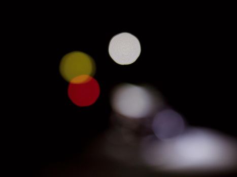 Lighting red, yellow and white bulbs, bokeh background black luxury night. Abstract multicolor lights, city night light blur bokeh colorful defocused background