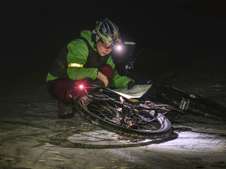Woman biker travel in extreme night snowy nature.  Sport and healthy life. Extreme sports. 