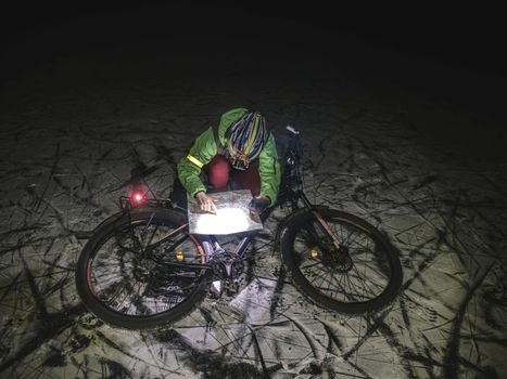 Cyclist on Mountain Bike on Snowy lake. Extreme Sports and Enduro Biking Concept