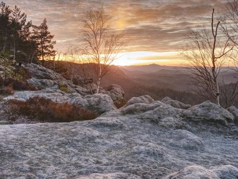 Dreamy beautiful mountain valley with a small hill peaks in the sunset rays