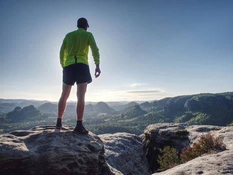 Male Sportsman in Running Shoes and Preparing for wild nature Run at Sunset. Healthy Lifestyle and Active Sport Concept