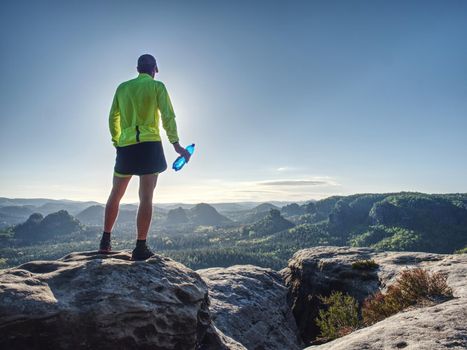 Trail runner run in natural terrain, body contour in low ankle view, detail if body.