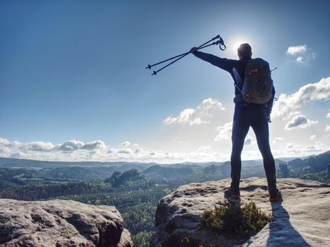 Tall man taking an excursion on a mountain. Mountain hiker looking at a far background 