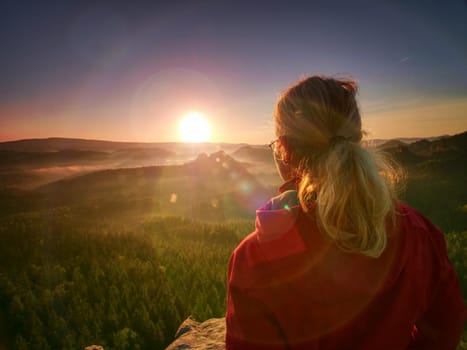 Beautiful blond hair woman looking outside. Woman head posing at the sunset, portrait of the young pretty woman