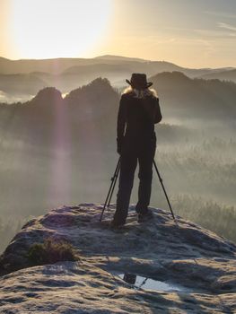 Woman nature art photographer works.  Takes photo and  walking in nature. Travel relax and nature study. 