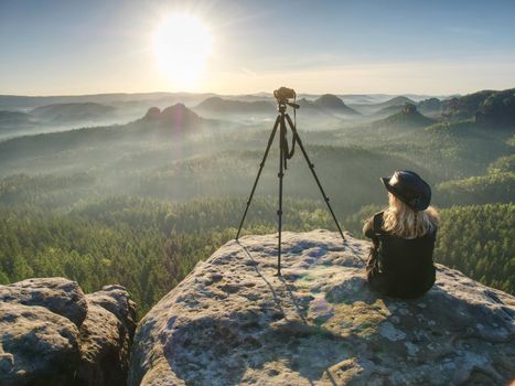 Woman hiker with leather hat conquer highest peak. Woman hiker traveling alone in nature. Mountain landscape. . Hipster hiker style.