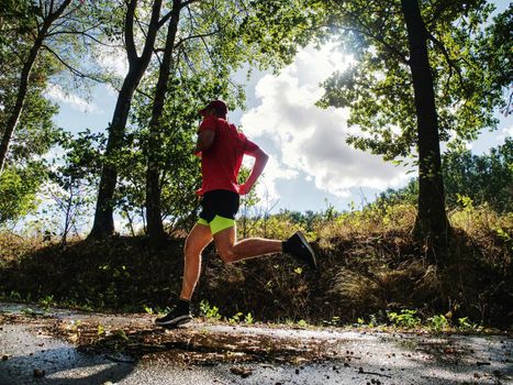 Recreation run during a sports activities in the open air forest. Summer running workout in health care and competition concept