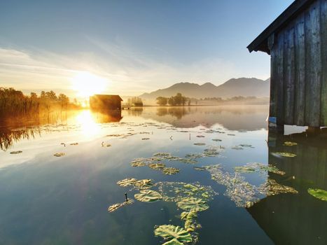 Traditional wooden boats old house at the alpine mountain lake. 