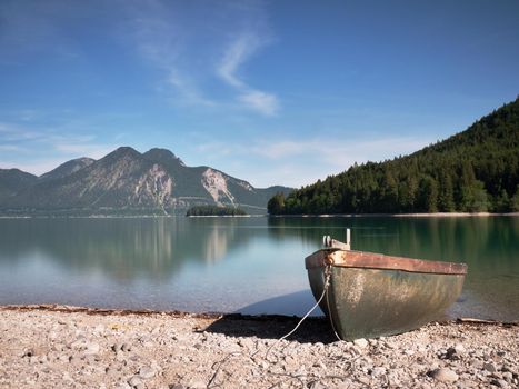 Pebbles  shore of beautiful German mountain lake in remote wilderness.