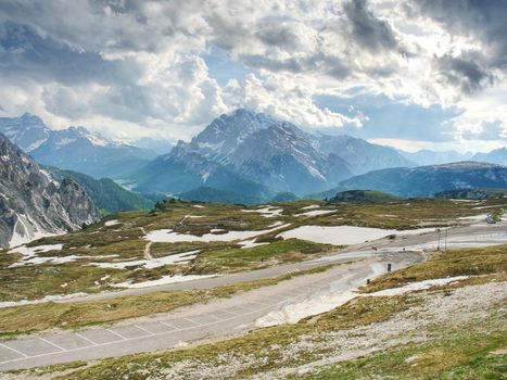 Asphalt road to parking place for motorhomes in National Nature Park Tre Cime In the Dolomites Alps, Italy.