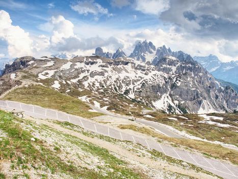 Asphalt road to parking place for motorhomes in National Nature Park Tre Cime In the Dolomites Alps, Italy.