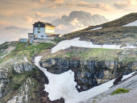 DOLOMITES, ITALY - May 26, 2018: Refugio Auronzo, Alpine hut 2333m, in Dolomites, Italy. Landmark stop for climbing the peaks of Dolomites Alps.