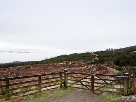 Old wooden fence on the edge of a hillside,  springtime landscape in mountains