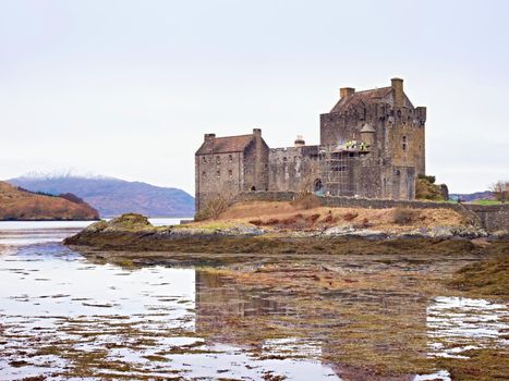 Eilean Donan Castle with a stone bridge above the water,  Scotland,  It was destroyed during the Jacobite rebellions in the early 18th century, and rebuilt