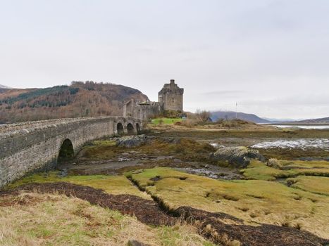 Eilean Donan Castle with a stone bridge above the water,  Scotland,  It was destroyed during the Jacobite rebellions in the early 18th century, and rebuilt