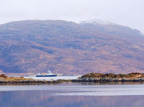 Popular view to Isle Ornsay Lighthouse. Rocky island south-east of Isle of Skye; Scotland, United Kingdom.