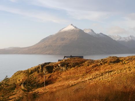 Evening at Loch Scavaig with Cuillins mountains in warm sunset light.  Isle of Skye Scotland