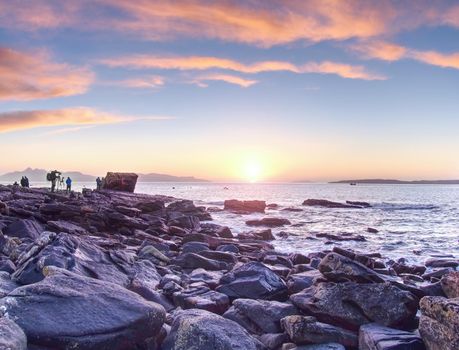 7th of February 2017, Isle of Skye, Scotland. Photographers take lesson in a sunset shooting workshop. Smooth sea level at an extremely long exposure.
