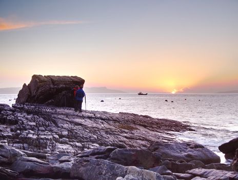 7th of February 2017, Isle of Skye, Scotland. Photographic workshop, landscaping photography lessons. Photographers take part in a sunset shooting with sea level at an extremely long exposure.