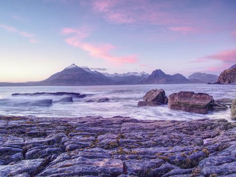 The famous rocky bay of Elgol on the Isle of Skye, Scotland.  The Cuillins  mountain in the background. Photographed at sunset.