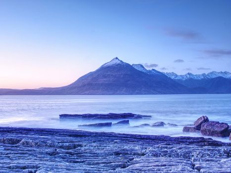 Evening at Loch Scavaig with Cuillins mountains in warm sunset light.  Isle of Skye Scotland