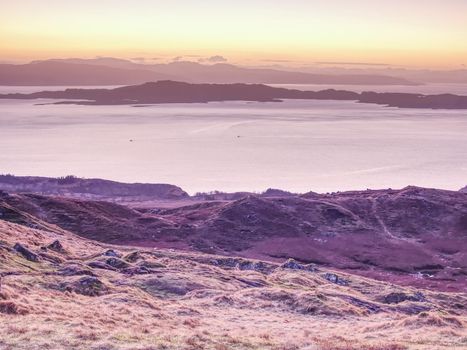 Highland Region Scotland United Kingdom , purople daybreak above sea at horizon