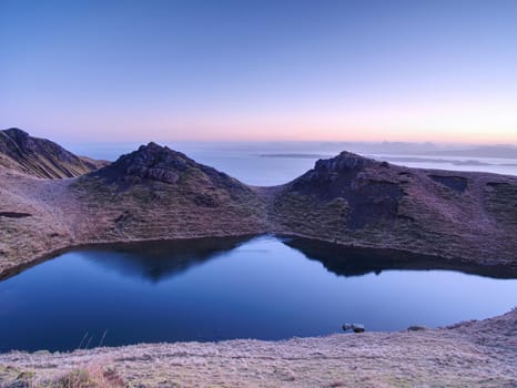 Small lake on the mountains and of Scottish Highlands. Scenic Landscape View of Mountain