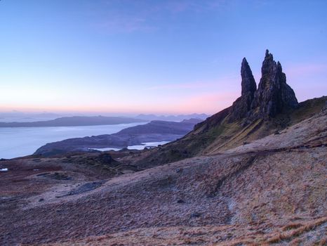 Sunrise at The Old Man of Storr - amazing scenery with vivid colors. Symbolic tourist attraction.  Scottish highlands in February morning