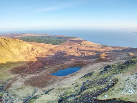 Small lake on the mountains and of Scottish Highlands. Scenic Landscape View of Mountain